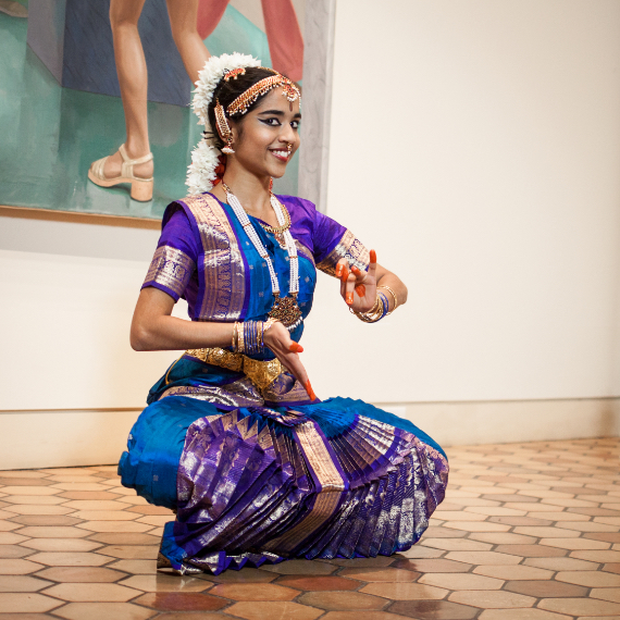 A young woman in traditional middle eastern clothing posing.